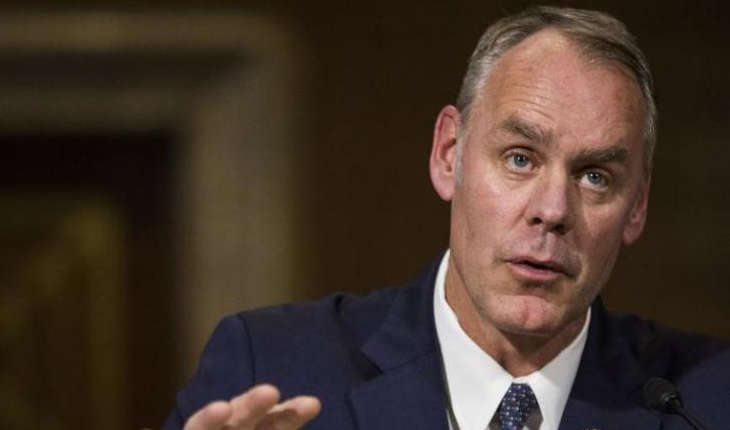 Ryan Zinke sitting at an official hearing.